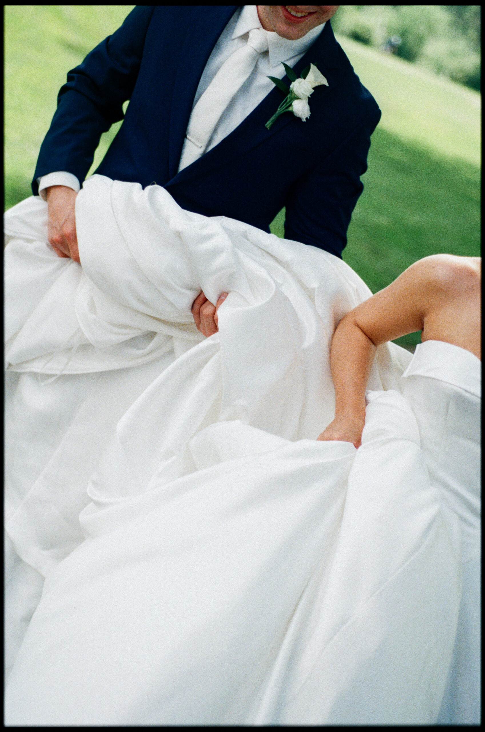 bride and groom holding dress